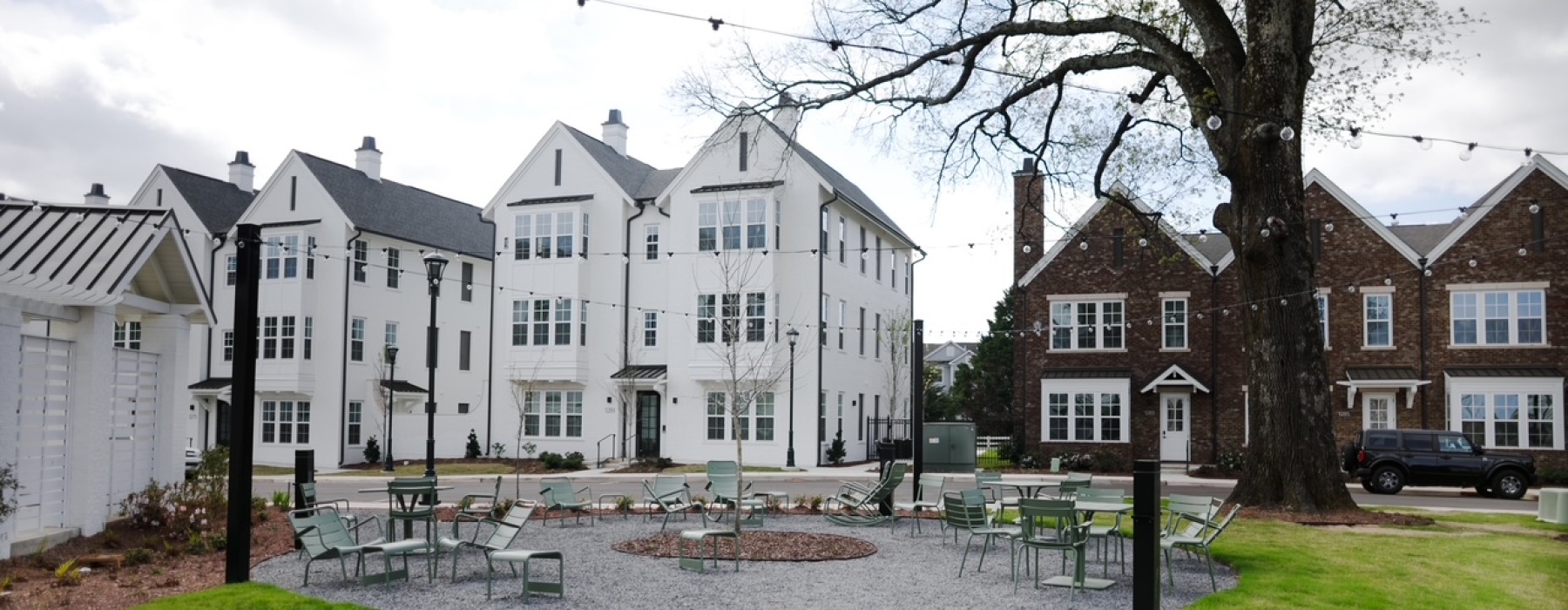 Beautiful greenspace and outdoor seating under mature Oak trees